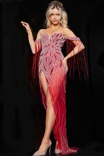 Model wearing Jovani 07031 red gown with beadwork and tassel sleeves