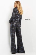 Model wearing Jovani 07166 showing back view of navy suit with long sleeves