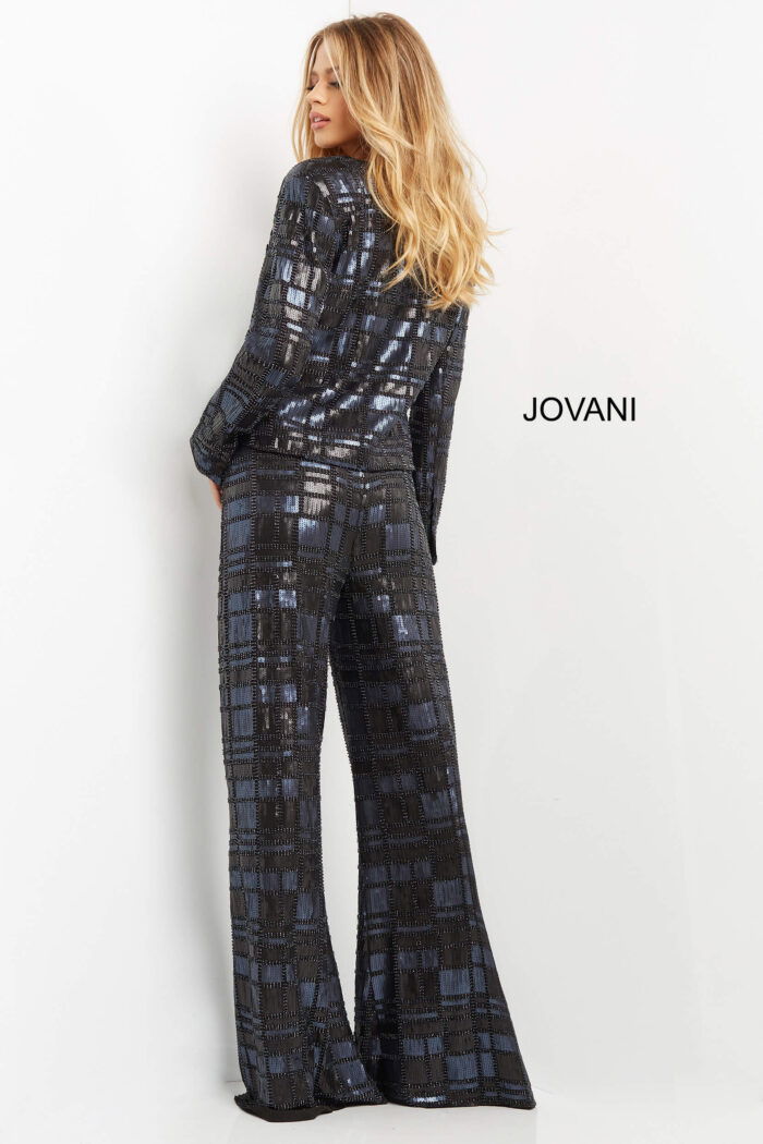 Model wearing Jovani 07166 showing back view of navy suit with long sleeves