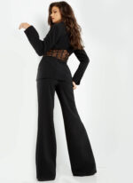 Back view of model wearing Jovani 07227 black pantsuit showcasing sheer netted waist feature.
