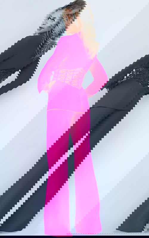 Back view of model wearing Jovani 07227 in fuchsia featuring lace-up waist and wide-leg pants.