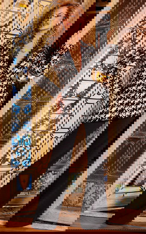 model wearing Jovani 07239 black ensemble with houndstooth jacket, front view