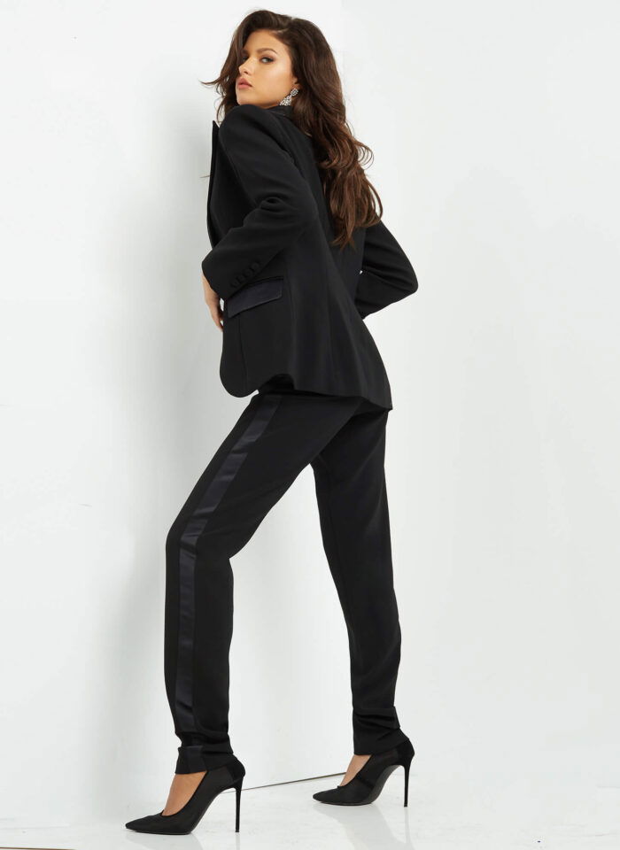 Model wearing Jovani 07293 black jumpsuit, back view.