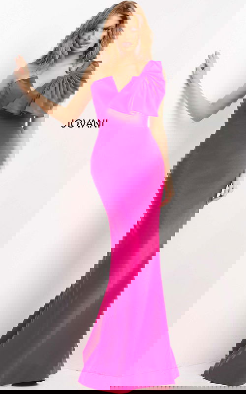 Model wearing Jovani 07306, fuchsia dress with asymmetric neckline and bow, front view.