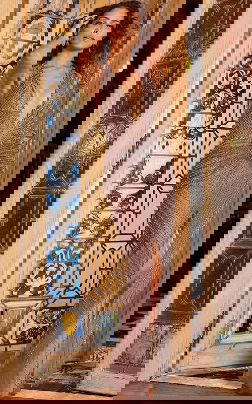 Model wearing Jovani 07380 elegant nude gown with plunging neckline and high slit, front view.