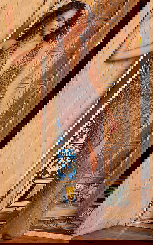 Model wearing Jovani 07380 nude gown with intricate beading and high slit, side angle.