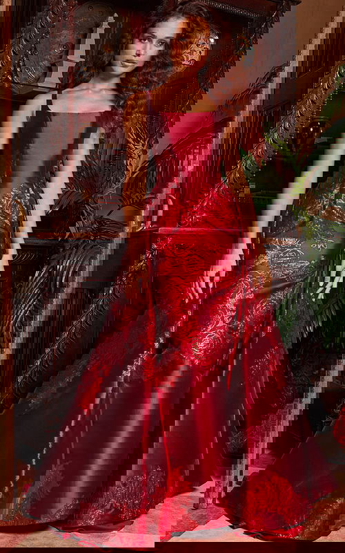 Model wearing Jovani 07441 purple gown with square neckline and intricate embroidery.