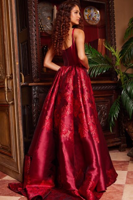 Back view of model in Jovani 07441 purple gown, displaying intricate back design and train.