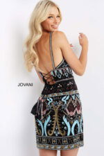 Model showing back of Jovani 08447 mini dress with lace-up detail, intricate patterns in multi colors.
