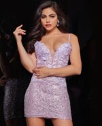Model wearing Jovani 07668 pink sequin dress with floral appliqués and V-neckline