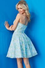Model wearing 07965 cocktail dress, back view, in a multi-colored floral pattern.