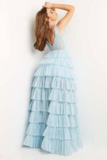 Model wearing Jovani 07998 sky blue gown with tiered skirt from the back view.