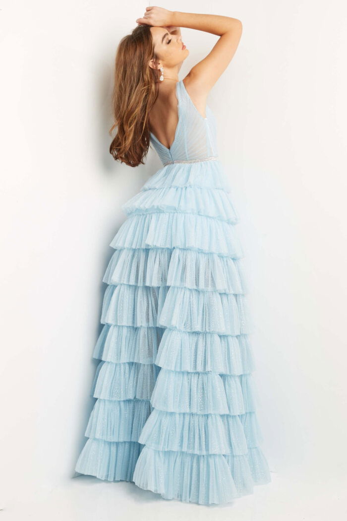Model wearing Jovani 07998 sky blue gown with tiered skirt from the back view.