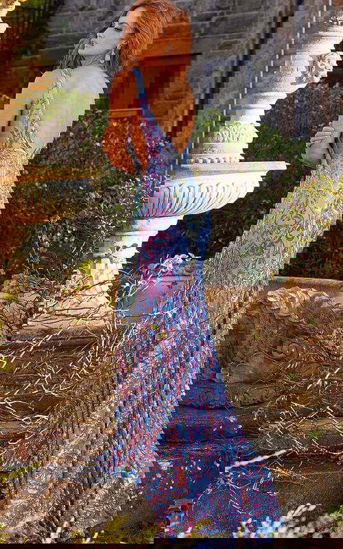 Model displaying the low scoop back of Jovani 08099 mermaid gown, rear view.