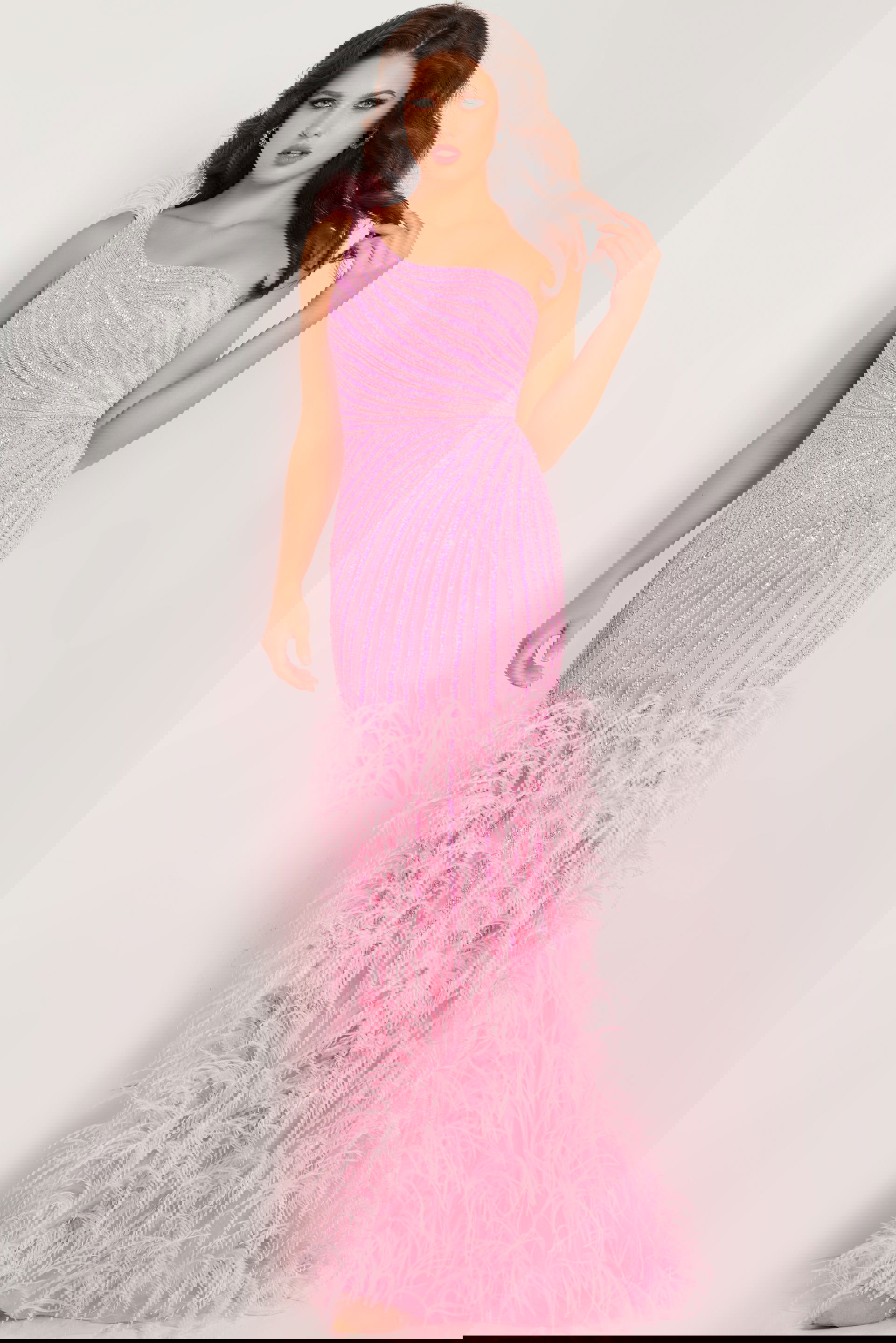 08200-pink.jpg Model wearing Jovani 08200 pink gown with asymmetric neckline and feathered skirt, front view.