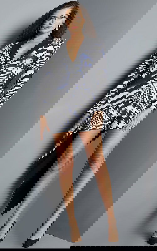 Model wearing Jovani 08343, black dress with geometric pattern and long sleeves.