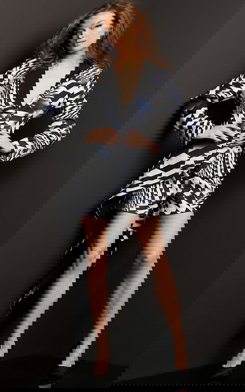 Model wearing Jovani 08343 front view, geometric print dress with plunging neckline and asymmetrical hem