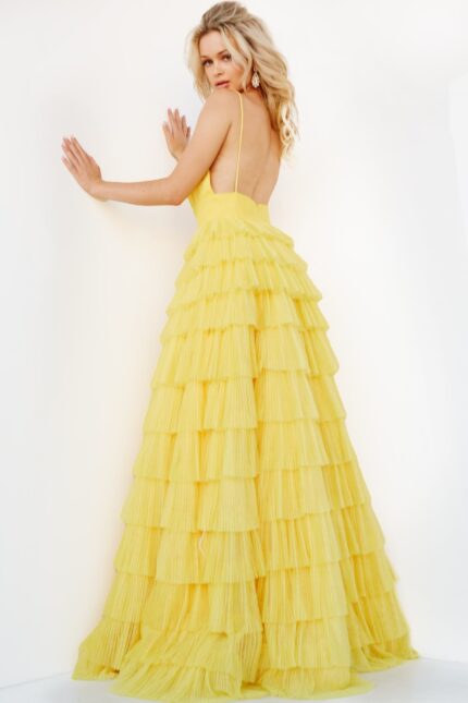 Model showing back of Jovani 08480 yellow gown, highlighting ruffle tiers.