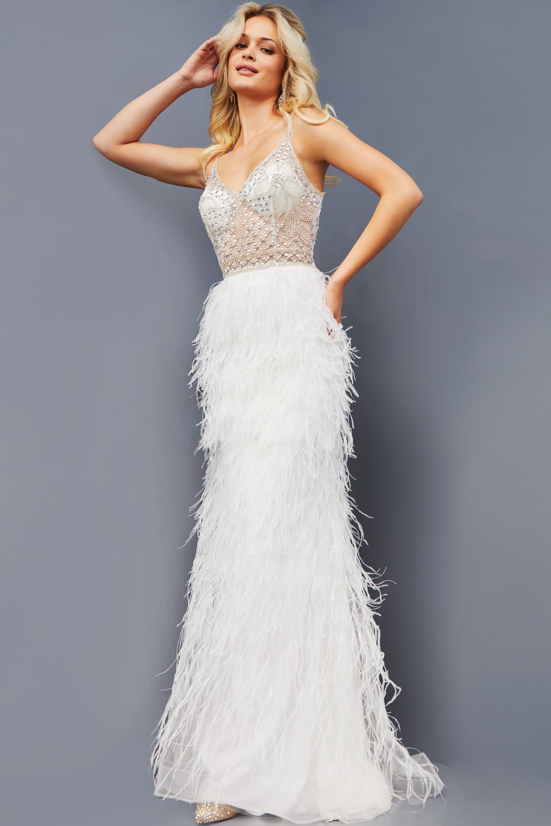 08525-OFFWHITE-202.jpg Model wearing Jovani 08525 front view of white gown with feathered skirt and sheer bodice.