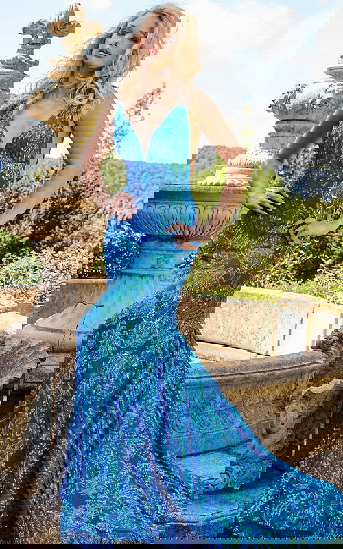 Model wearing Jovani 08646 Royal gown with v-neckline and sequined embellishments.