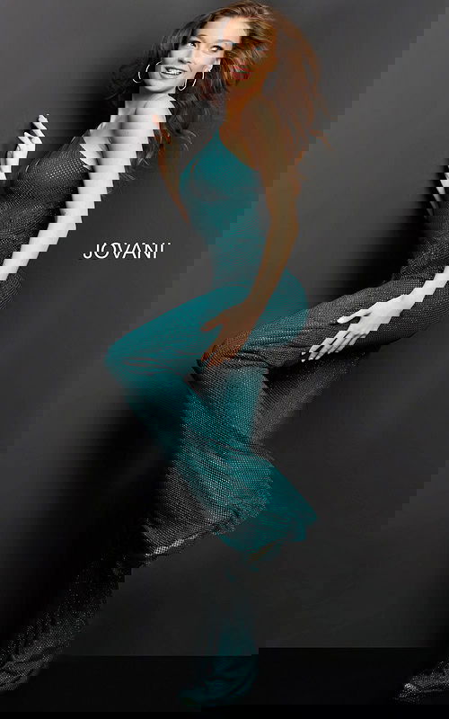 Model wearing Jovani 09018 green jumpsuit, side view