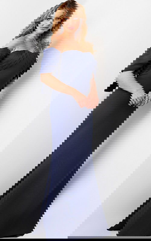 Model wearing Jovani 09064 navy dress with off-the-shoulder design and pleated bodice.