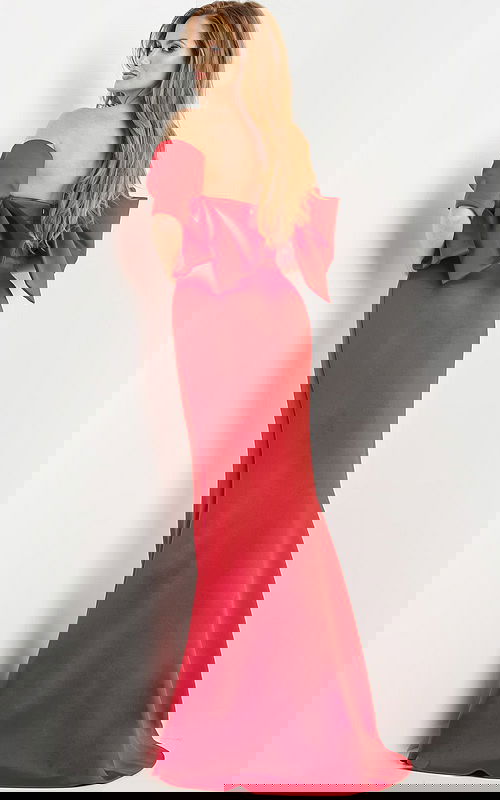 Model wearing Jovani 09064 red dress showing the back and large bow detail.