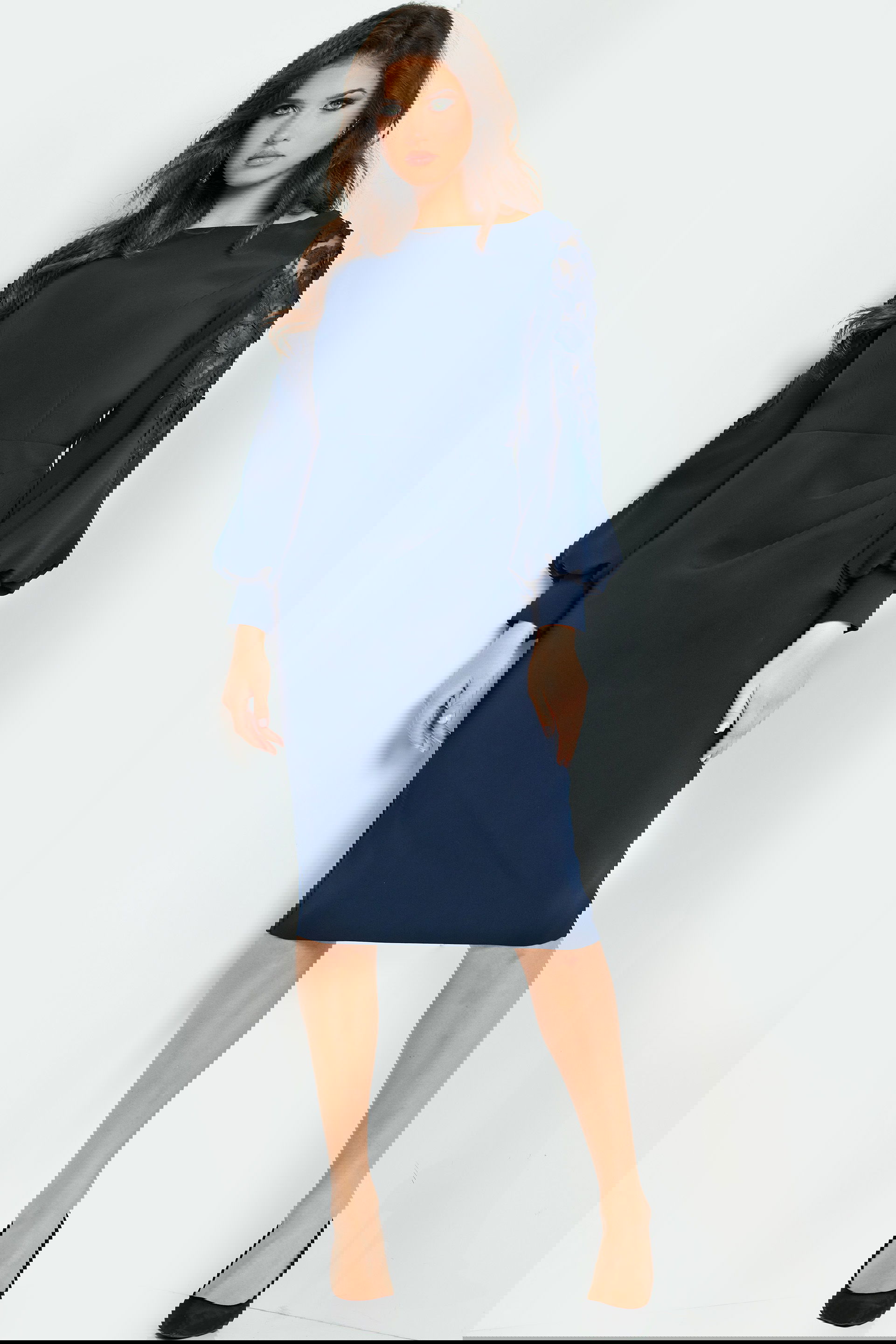 09471-NAVY-208.jpg Model wearing Jovani 09471, a knee-length navy dress with balloon sleeves and boat neckline, front view