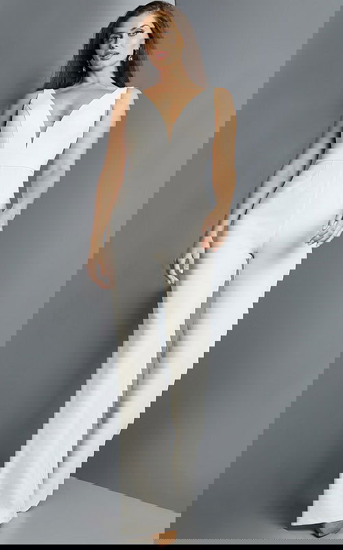 Model wearing Jovani 09479 ivory jumpsuit from the front with deep V-neckline