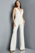 Model in Jovani 09479 ivory jumpsuit with V-neckline and wide-leg pants