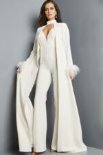 Model wearing Jovani 09479 ivory jumpsuit with coat and feathered cuffs from the front