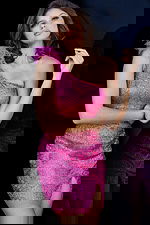 Model wearing Jovani 09483 in hot pink with a one-shoulder design and feather detail.