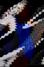 Model in Jovani 09483 royal blue dress with a one-shoulder design and high slit.