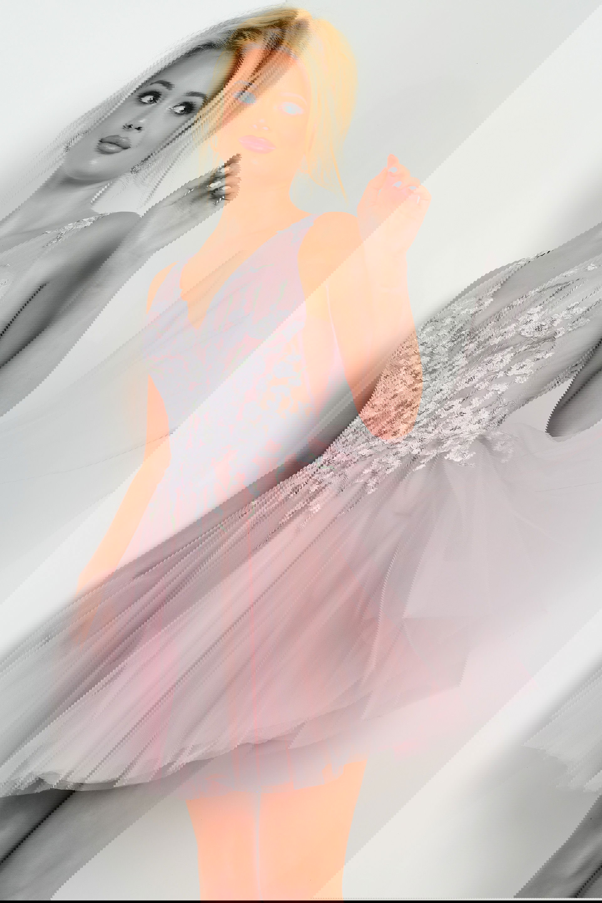 09518-MAUVE-206.jpg model wearing Jovani 09518 blush mini dress with floral applique and V-neckline