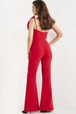 Model wearing Jovani 09525 red jumpsuit, back view showing zipper closure.