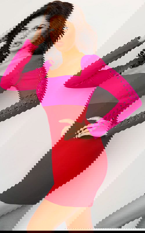 Model wearing 09586 dress in fuchsia and red with square neckline and lace-up long sleeves, front view.