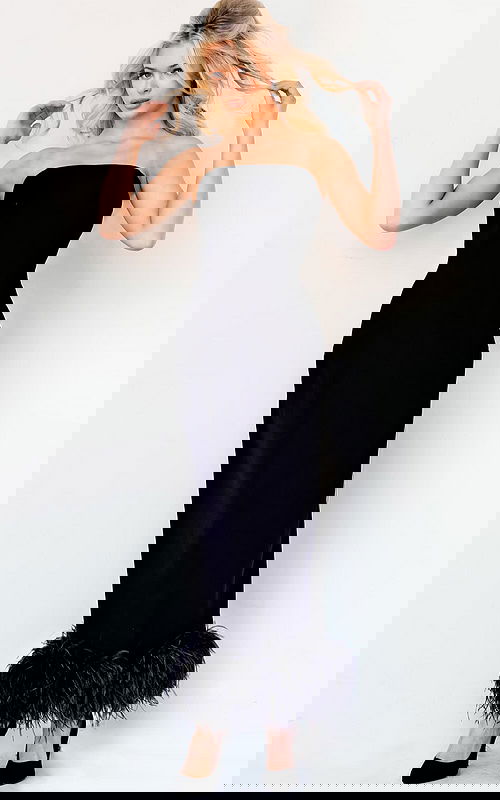 Model wearing Jovani 09630 black evening dress with feather trim, front view.