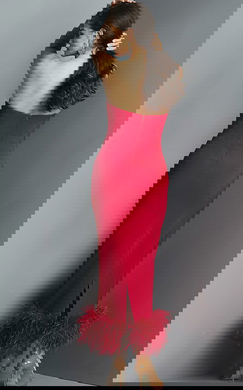 Model wearing Jovani 09630 red dress with feathered hem, back view.