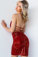 Model wearing Jovani 09694 red sequin dress showing open back.