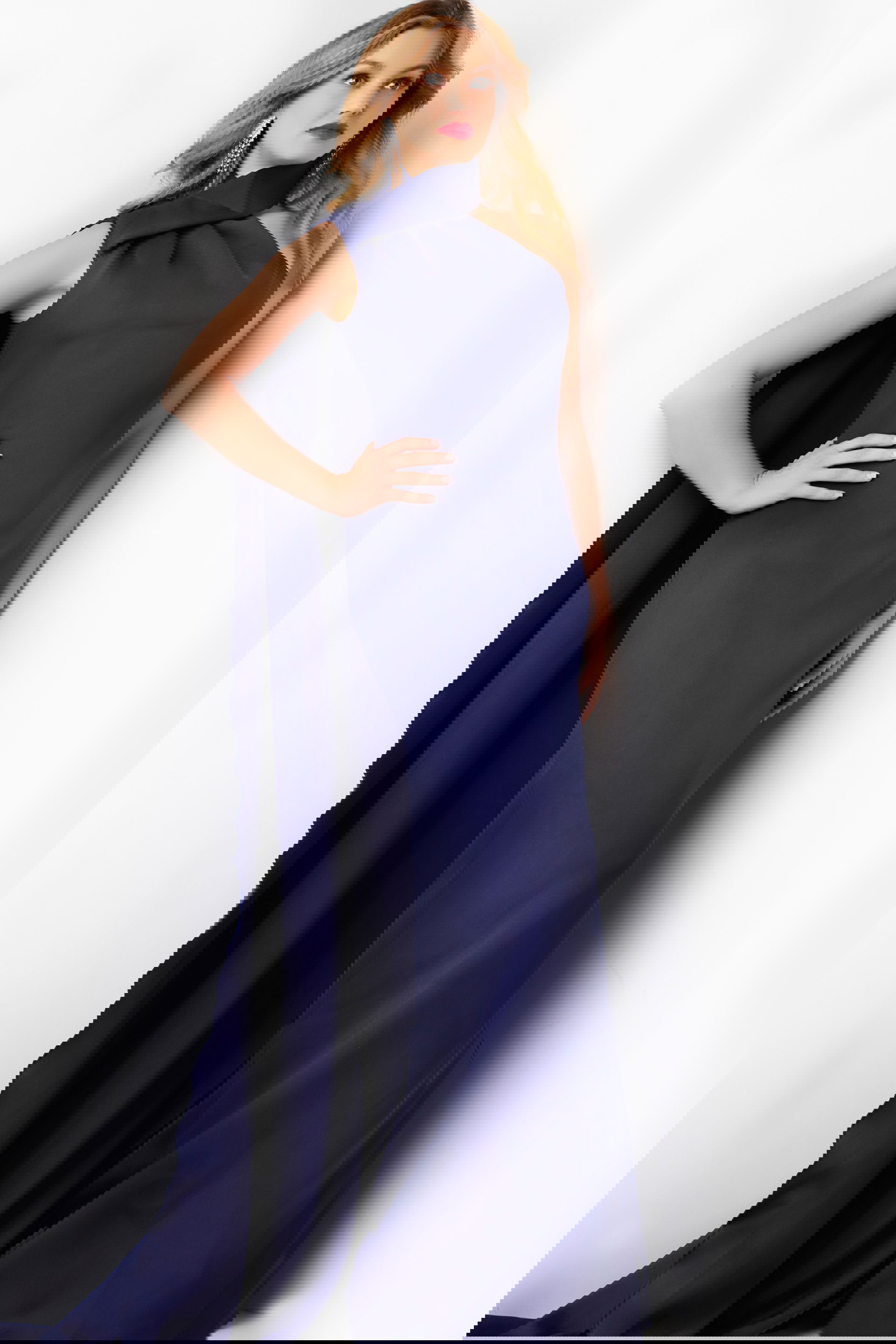 09709-NAVY-26.jpg Model wearing Jovani 09709 navy dress with one-shoulder neckline and cape, front view.