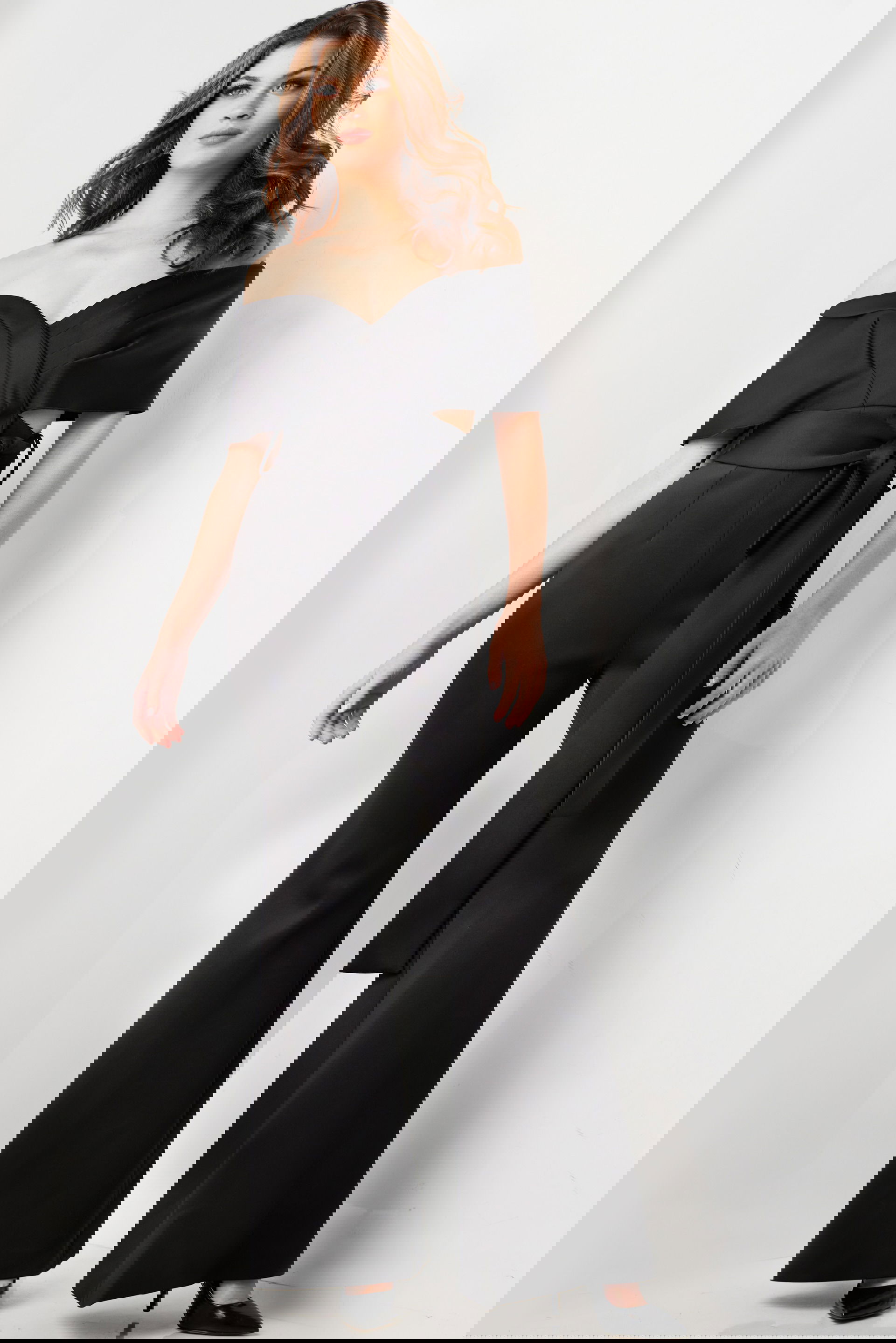 09726-BLACK-3.jpg Model wearing Jovani 09726 black off-the-shoulder jumpsuit, front view