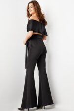 Model wearing Jovani 09726 black off-the-shoulder jumpsuit, back view