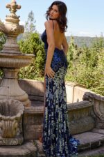 Back view of model in Jovani 09749 navy dress with open back design.