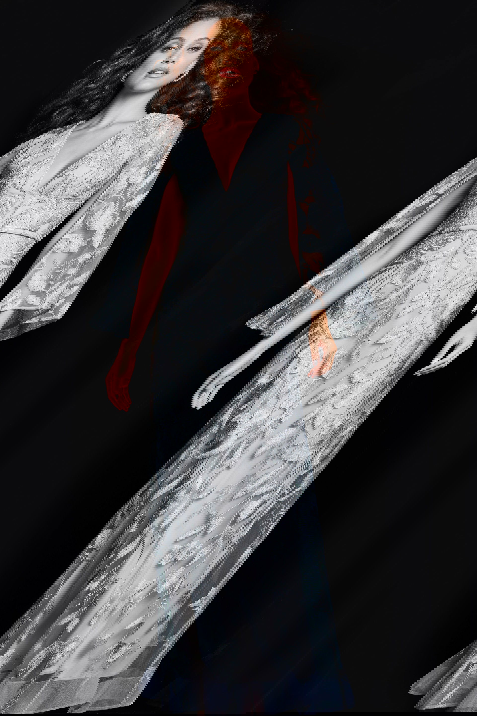 09809_SILVER_21-2.jpg Model wearing Jovani 09809 silver gown with V-neckline and cape sleeves.