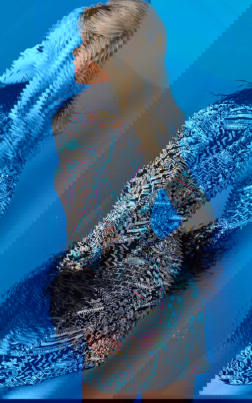 Model wearing Jovani 09818 vibrant multi-color fitted mini dress from the back, showcasing intricate detailing.