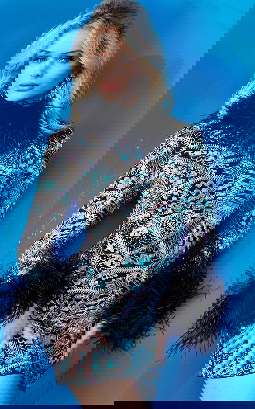 Model wearing Jovani 09818 vibrant multi-color fitted mini dress from the front, featuring a high neckline and feather details.