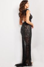 Back view of model wearing Jovani 09879 black gown with feather details.