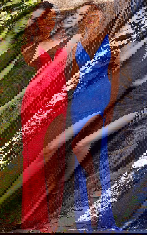 two models wearing Jovani 09891 dresses in red and royal with V-neckline and high slit