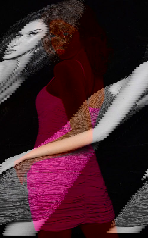 Model wearing Jovani 09914 fuchsia mini dress from back view.