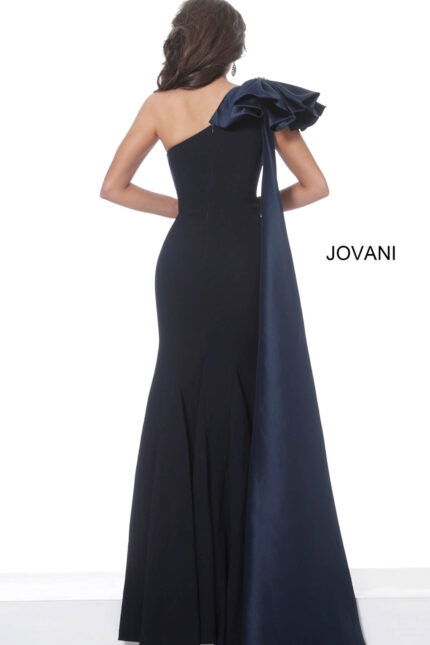 Back view of model wearing Jovani 1008 navy dress with one shoulder and dramatic ruffle detail.